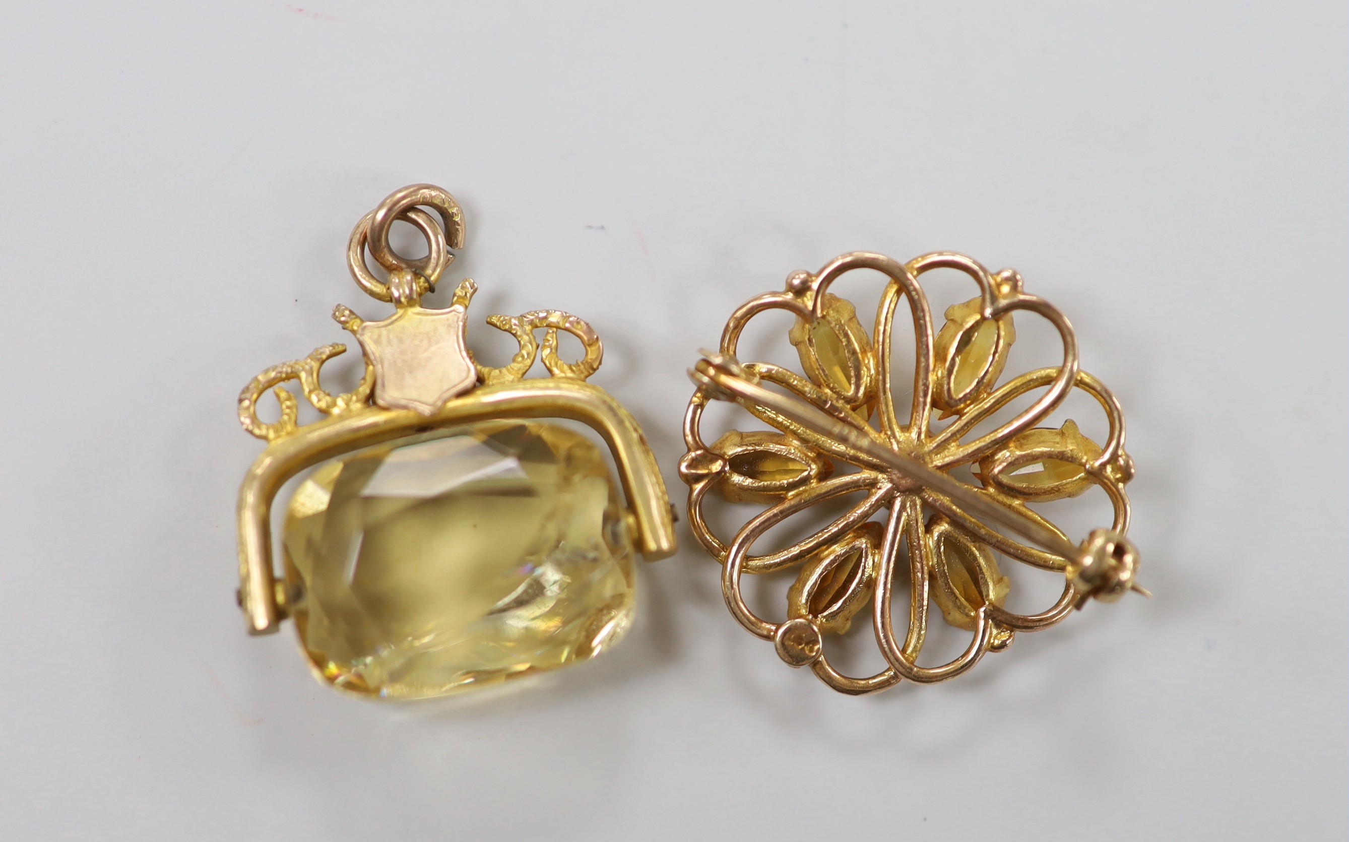 A George V 9ct gold mounted citrine spinning fob pendant, 26mm and a 9ct, citrine and cultured pearl cluster set brooch, gross weight 11.9 grams.